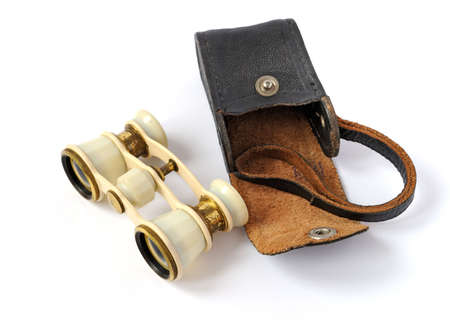 old opera glasses with a leather handbag on white backgroundの写真素材