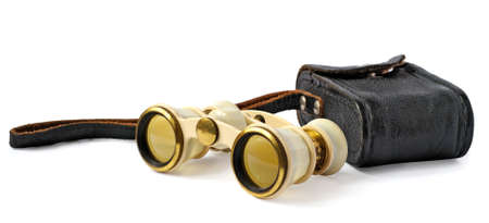 old opera glasses with a leather handbag on white backgroundの写真素材