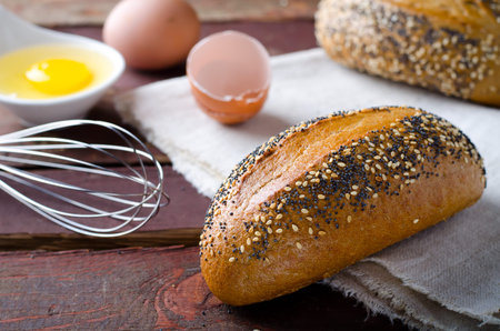 Freshly baked small breads with sesame and poppy seeds. Selective focusの写真素材