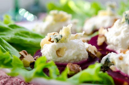 Beet Salad with goat cheese, walnuts, greens and herbs and olive oilの写真素材