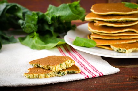 Vegetarian gluten free Spinach pancakes on wooden backgroundの写真素材