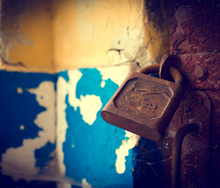 Old rusty lock on the vintage rural wooden doorの写真素材