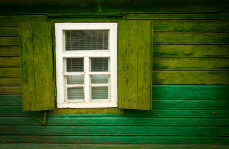 Old vintage open wooden window on the green wallの写真素材