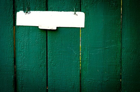 The old vintage wooden fence with metal sign, green colourの写真素材