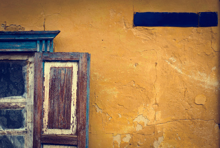 Old rusty sign with the street name and window on the wallの写真素材