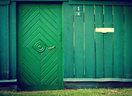 The old vintage wooden doors and fence, green colour