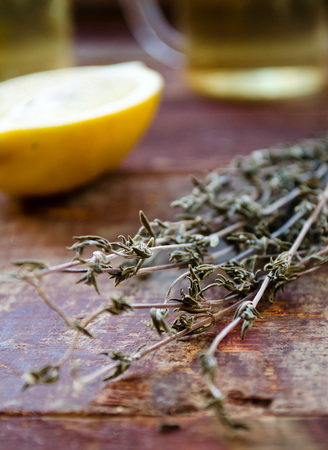 ginger tea with lemon and dry thyme on wooden tableの写真素材