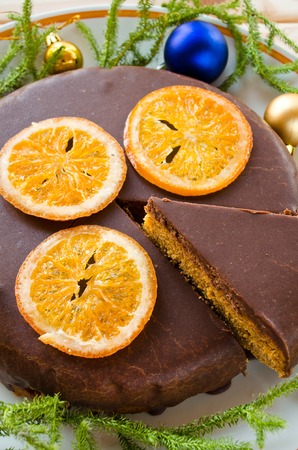 Carrot cake with chocolate topping and caramelized orangesの写真素材