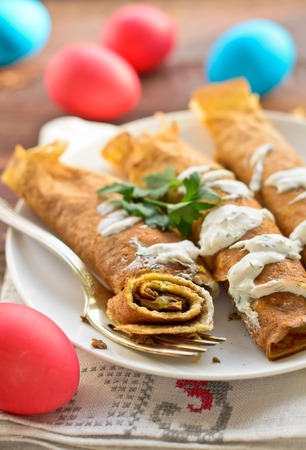Easter eggs and pancake rolls with mushrooms and yogurt dipの写真素材