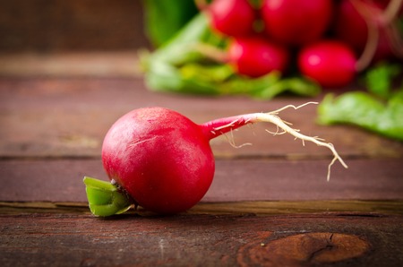 Large bunch of fresh Organic vegetables, radish on old wooden table, closeupの写真素材