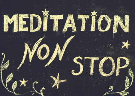 Meditation non stop sign, message written with chalk on blackboard. Healthy mind, body and spirit concept.の写真素材