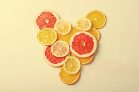 Citrus fruit Heart from slices of lemon, orange, grapefruit on white background. Love, healthy, ecology concept.の写真素材