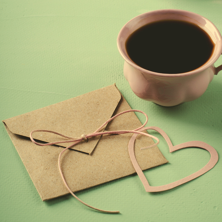 Love letter, envelope and pink cup of coffee. Valentines card. Horizontal, flat layの写真素材
