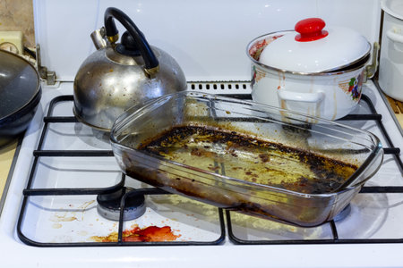 Dirty gas stove. Stove after cooking. A mess in the kitchen.の写真素材