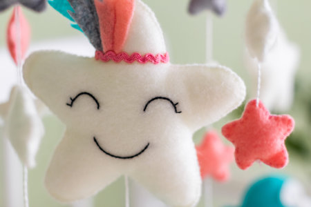 Colorful and eco-friendly childrens mobile from felt for children. It consists of toys clouds, stars...