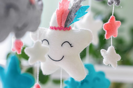 Toys above the baby crib. Baby crib mobile with stars, clouds and moon.の写真素材