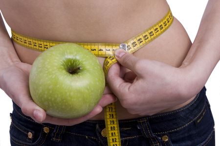 Fit woman with measure tape isolated over white. Weight loss and healthy lifestyle concept. Girl measuring waist with a tape measure. Isolated.
Woman hold apple in hand. Waist is 65.5 centimeters.
の写真素材