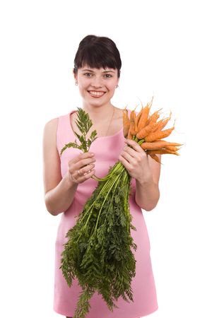 Picture of a beautiful smiling girl holding bunch of carrots against background. Full isolated portrait of a beautiful caucasian woman with carrot. Isolated over white background.
の写真素材