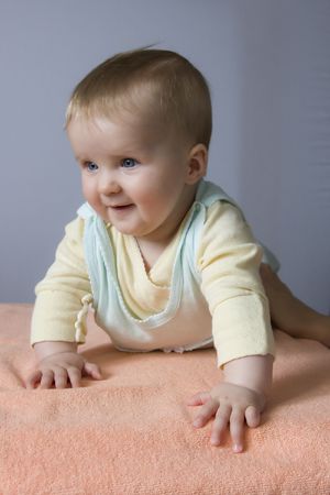 Baby is lying on the bed. Photo of child. Baby is 6 months.の写真素材