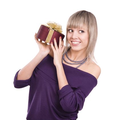 Beautiful smiling woman with a gift. Attractive girl holding purple box with gold ribbon. Beautiful  lady is thinking about something.の写真素材