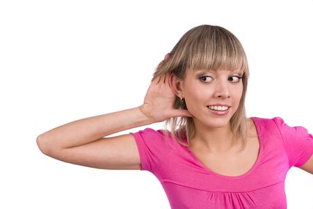 Young attractive woman listening gossip isolated on white. Beautiful female eavesdropping. Female trying to hearing the sound around her.の写真素材