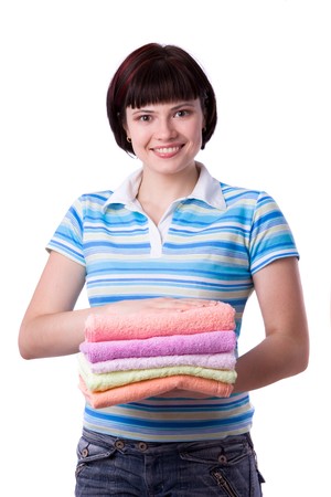 Housewife with clean laundry.  A young woman holding clean towels. Time for laundry day.   の写真素材