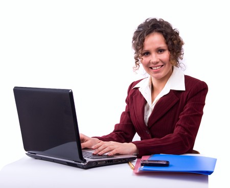 Female sitting with a laptop. Happy young businesswoman sitting on chair with laptop on lap looking at camera. Smiling business woman working on computer.の写真素材