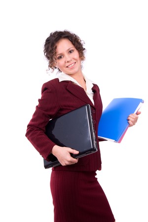 Female with  laptop and files. Happy young businesswoman holding folders and laptop and looking at camera. Smiling business woman working on computer.の写真素材