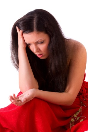 Very sad woman suffers and struggles because of infidelity. Girl feeling sad, depressed, grief. Distraught woman is very upset and holding gold wedding ring.の写真素材