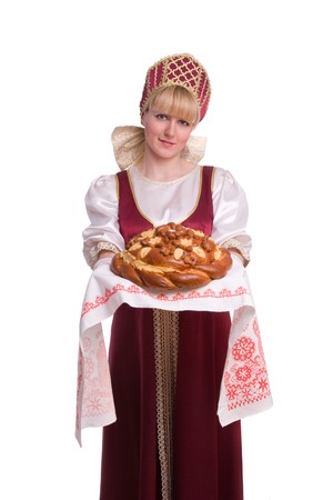 Bread-and-salt welcome. A traditional ritual of offering bread and salt to a welcome guest. Girl standing in Russian traditional costume. Woman is wearing sarafan and kokoshnik. 
の写真素材