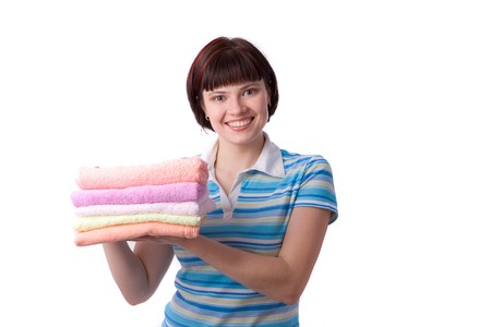 Housewife with clean laundry.  A young woman holding clean towels. Time for laundry day.   の写真素材