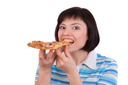 Young happy woman eating pizza, isolated on white. portrait of young woman holding piece of pizza.の写真素材