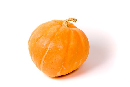 Orange pumpkin isolated on a white background with a drop shadow.の写真素材