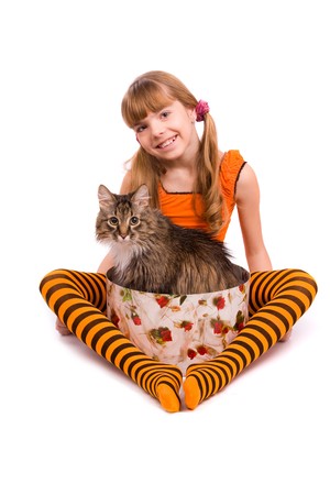 Little girl in the orange dress is sitting on the floor. Portrait of an attractive young teenager is smiling in orange over white background.の写真素材