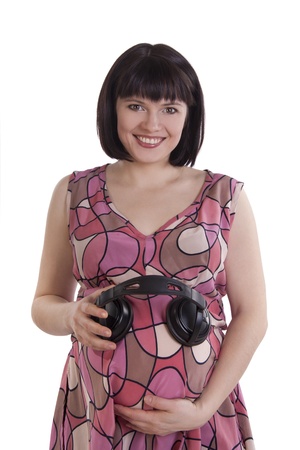 Pregnant Woman with Headphones on  Belly.の写真素材