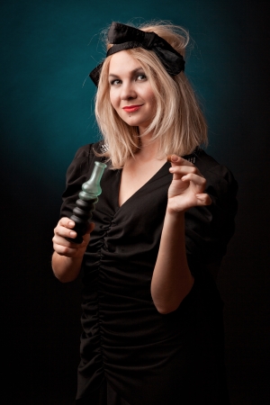 Witch practises witchcraft on black background の写真素材