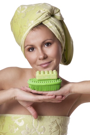 Beautiful girl in a green towel keeps bathの写真素材