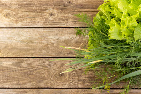Top view green salad on textured wooden background, free space for textの写真素材