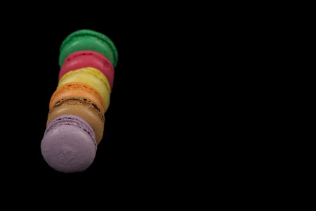 Stacks of multicolored macaroon isolated on black background frameの写真素材