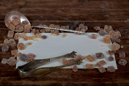 Old spoons and brown sugar cubes with place for text. Top viewの写真素材
