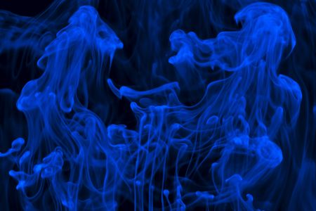 Blue liquid in water making abstract formsの写真素材