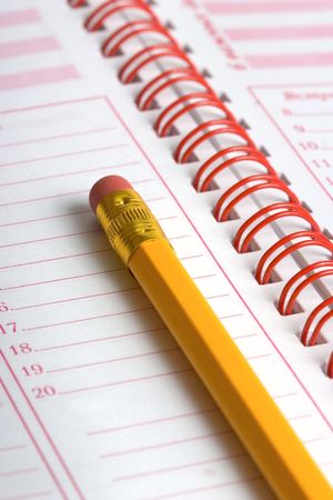 Open day planner with a pencilの写真素材