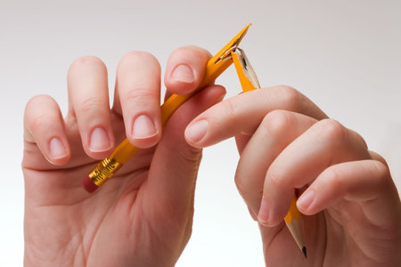Hand with a pencil, on a blank white paper.の写真素材