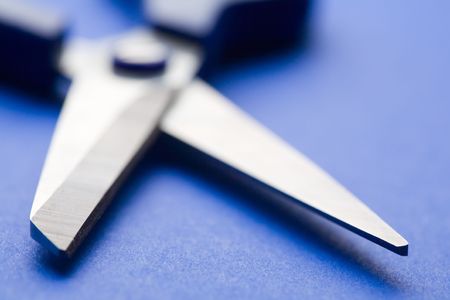 open shears on blue background. Small DOFの写真素材