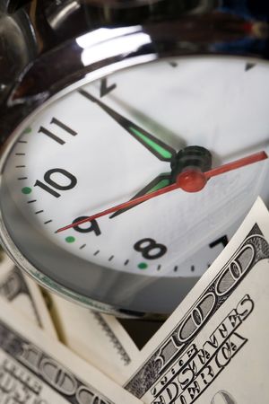 close up of the oldfashioned alarm clock and moneyの写真素材
