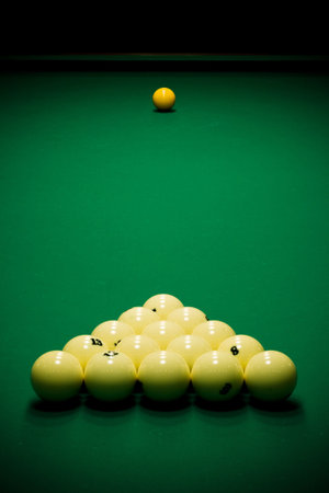 Yellow sphere on a billiard table in a night club