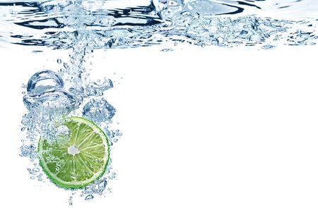 A background of bubbles forming in water after strawberries are dropped into it.の写真素材