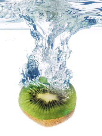 Bubbles forming in blue water after kiwi is dropped into it.の写真素材