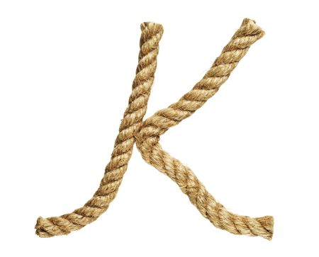 old natural fiber rope bent in the form of letter Kの写真素材