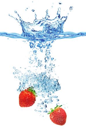 A background of bubbles forming in water after strawberries are dropped into it.の写真素材